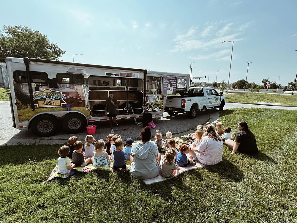 Shooting Stars students watching cow milking demonstration