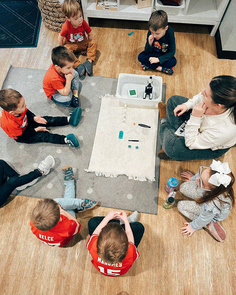 Montessori teacher leading a hands-on learning experience at Shooting Stars Montessori.