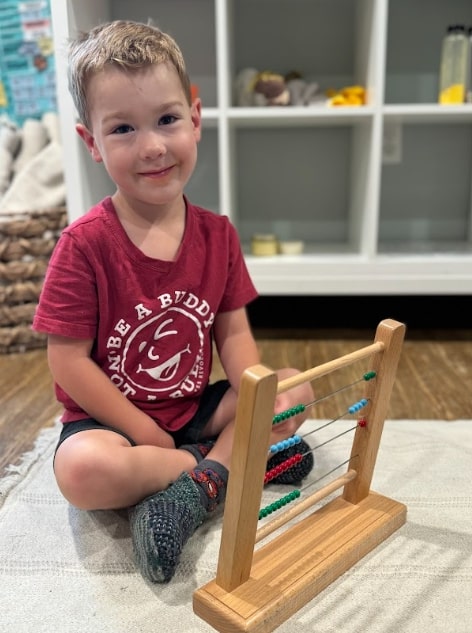 Montessori child working with math materials