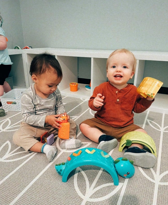 A toddler developing fine motor skills with Montessori material.