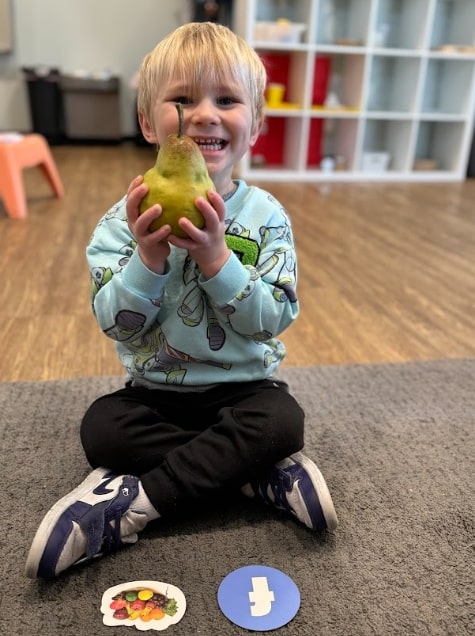 Smiling child engaged in hands on learning activity