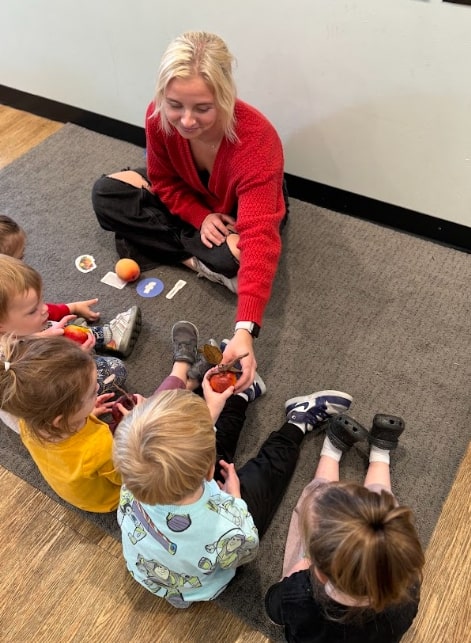 Montessori teacher interacting with students during a lesson