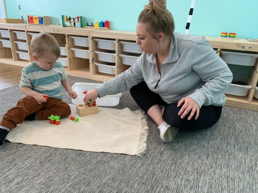 Montessori teacher guiding a student in a personalized lesson