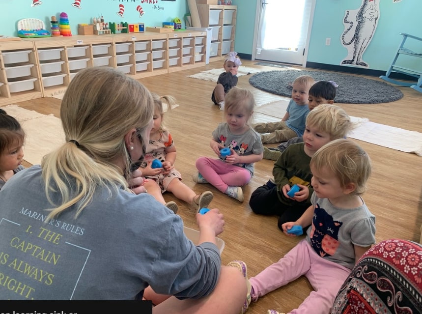 Montessori teacher interacting with students - hands on learning sink or float