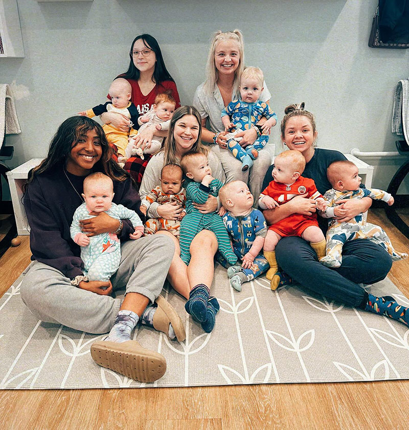 Teachers holding babies sitting together